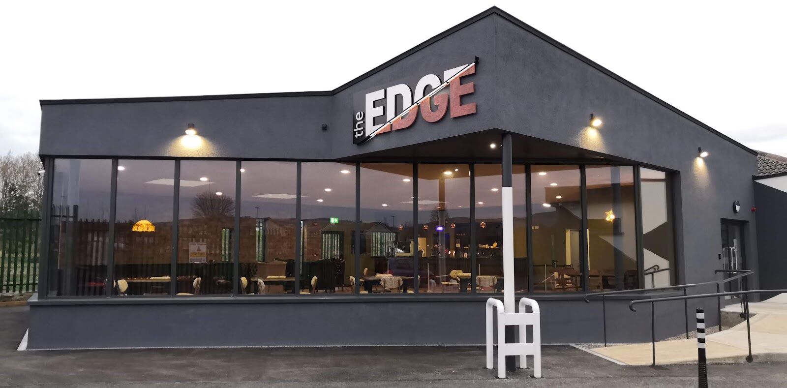 The Edge building at dusk, with its glazed frontage and the EDGE sign above the entrance.